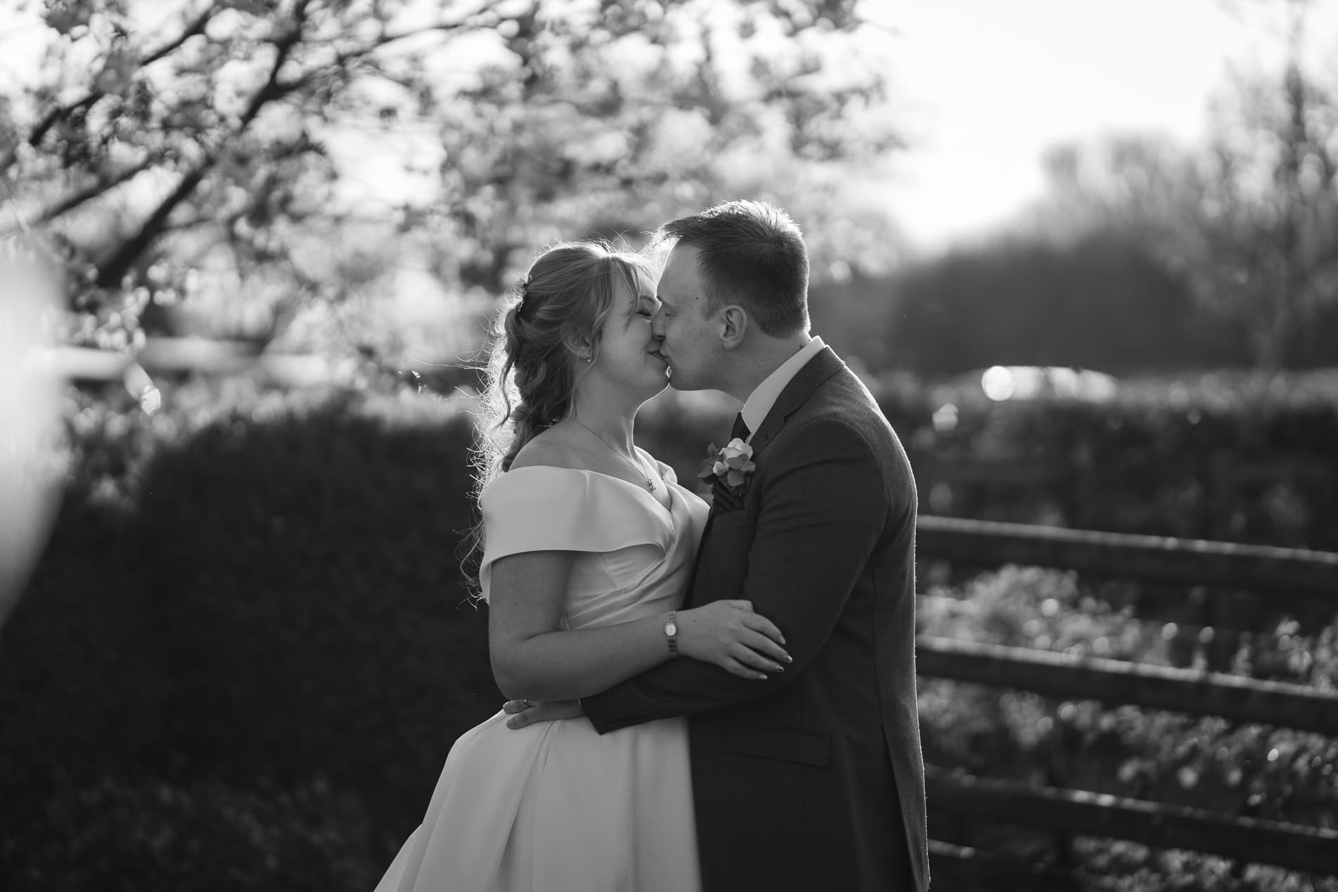 black and white wedding couple portrait, couple kissing wedding at Mythe Barn